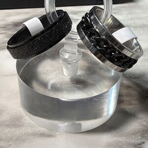 2 SIZE 8 RINGS SILVER SPARKLE IS SPINNER OTHER IS BAND WITH BLACK CENTER (2732)